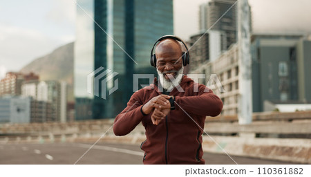 Man, music and smart watch in city for exercise, fitness performance and workout results. Happy senior african runner check timer, clock and healthy training progress with headphones in urban road 110361882