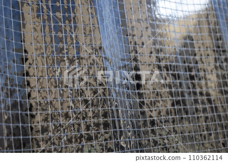 Close-up background of transparent vinyl curtain with flame retardant thread Close-up background of transparent vinyl curtain with flame retardant thread 110362114