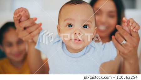 Portrait, baby and holding hands with a family in the living room of their home together for bonding. Face, cute or adorable with an infant boy, his mother and sister in their apartment closeup 110362254