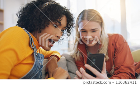 Friends, phone and talking on a home sofa with internet connection, social media and online chat. Women laughing together on a couch with a smartphone for communication, surprise or wow gossip Friends, phone and talking on a home sofa with internet connection, social media and online chat. Women laughing together on a couch with a smartphone for communication, surprise or wow gossip 110362411