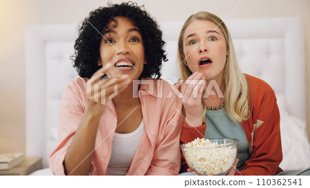 Horror, television and women friends with popcorn on bed for scary, movie or serial killer documentary at home. Watching tv, face and ladies in bedroom with terror, film or video, snack and streaming Horror, television and women friends with popcorn on bed for scary, movie or serial killer documentary at home. Watching tv, face and ladies in bedroom with terror, film or video, snack and streaming 110362541