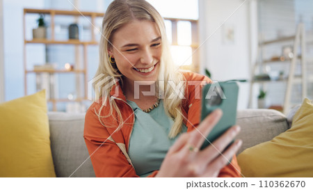 Woman, smartphone typing and laugh on sofa in home, reading social media and app. Face of happy gen z girl scroll on cellphone for funny meme, download mobile games and search network in living room Woman, smartphone typing and laugh on sofa in home, reading social media and app. Face of happy gen z girl scroll on cellphone for funny meme, download mobile games and search network in living room 110362670