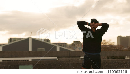 Man, runner and success view in city training victory, fitness progress or cloudy morning cardio. Male person, athlete or relax arms or achievement workout performance, exercise goal or challenge win 110363116