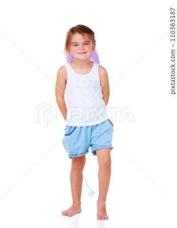 Portrait, smile and an adorable girl child hiding a balloon in studio isolated on a white background. Children, playful or having fun with a full length cute young kid looking happy during a game 110363187