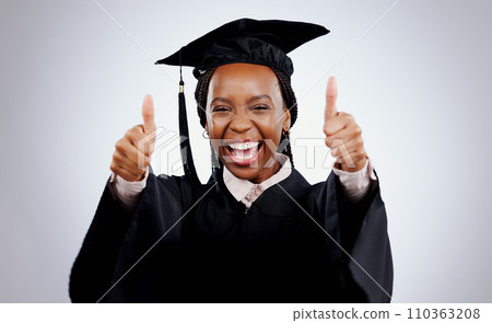 Graduation cap, woman and thumbs up for study success, celebration and education, learning or college in studio. Portrait of excited African graduate or student with like emoji on a white background 110363208