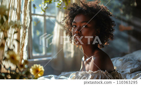 Young woman sitting in her bed, looking at the camera, World Sleep Day banner. Scandinavian-style bedroom, permeated with the rays of the summer sun Young woman sitting in her bed, looking at the camera, World Sleep Day banner. Scandinavian-style bedroom, permeated with the rays of the summer sun 110363295