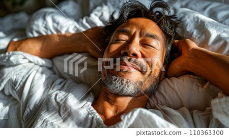 Portrait of an adult man smiling in his sleep, sunlight on his face, World Sleep Day concept Portrait of an adult man smiling in his sleep, sunlight on his face, World Sleep Day concept 110363300