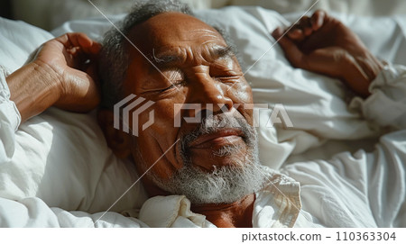 Portrait of an elderly man sleeping happily in his bed and smiling in his sleep, World Sleep Day concept Portrait of an elderly man sleeping happily in his bed and smiling in his sleep, World Sleep Day concept 110363304