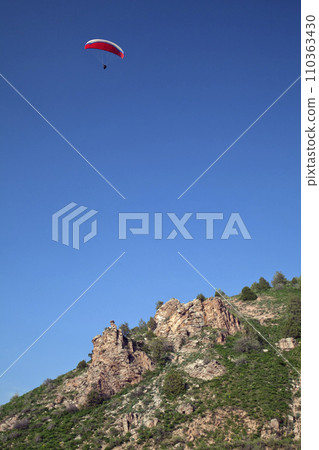 Parasailing in a blue sky 110363430