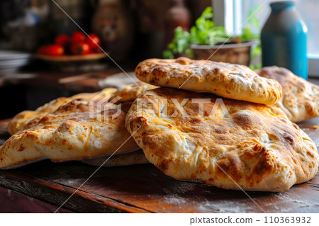 Fresh bread from the bakery next door, favorite bakeries near the house, traditional Georgian Puri bread on an old wooden table, the freshest fragrant bread 110363932