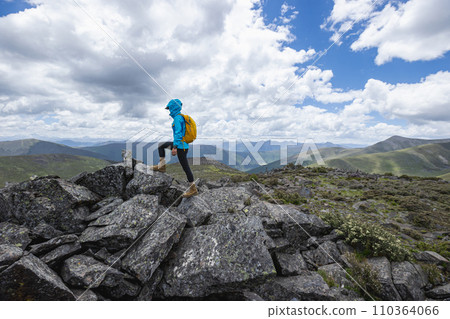 Hiking woman on high altitude mountain top Hiking woman on high altitude mountain top 110364066