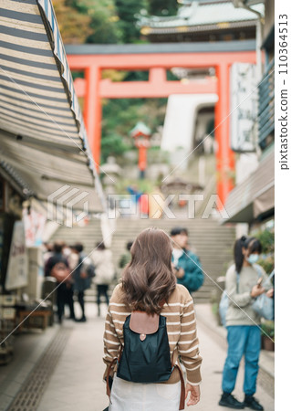 Woman tourist Visiting in Enoshima Island, Fujisawa, Kanagawa, Japan. happy Traveler sightseeing Enoshima Shrine. Landmark and popular for tourists attraction near Tokyo. Travel and Vacation concept Woman tourist Visiting in Enoshima Island, Fujisawa, Kanagawa, Japan. happy Traveler sightseeing Enoshima Shrine. Landmark and popular for tourists attraction near Tokyo. Travel and Vacation concept 110364513