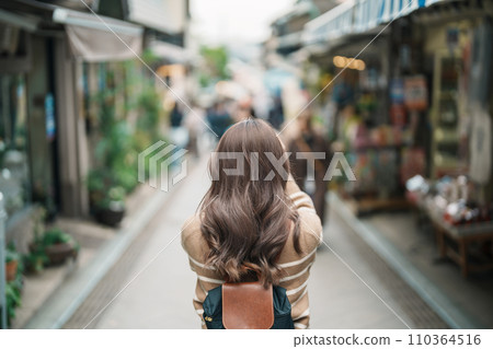 Woman tourist Visiting in Enoshima Island, Fujisawa, Kanagawa, Japan. happy Traveler sightseeing Enoshima Shrine. Landmark and popular for tourists attraction near Tokyo. Travel and Vacation concept 110364516