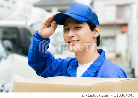 Smiling young man carrying luggage 110364743