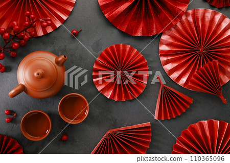 Chinese new year festival decorations with classic clay teapot and red Chinese folded fans. 110365096