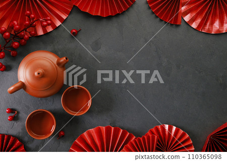 Chinese new year festival decorations with classic clay teapot and red Chinese folded fans. 110365098