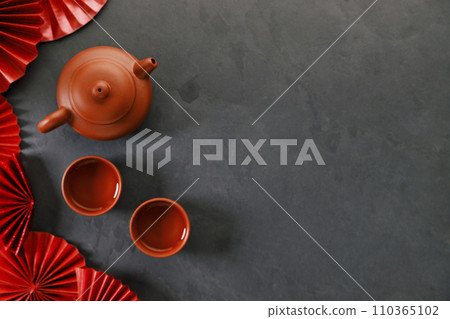 Chinese new year festival decorations with classic clay teapot and red Chinese folded fans. 110365102