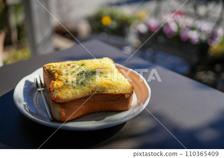 Egg toast eaten on the terrace of a cafe Egg toast eaten on the terrace of a cafe 110365409