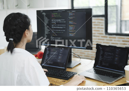 IT Programmer Starts Working on Desktop Computer. 110365653
