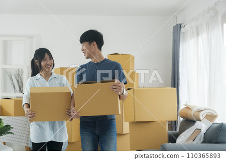 Asian young happy new married couple moving to their new house or real estate. Asian young happy new married couple moving to their new house or real estate. 110365893
