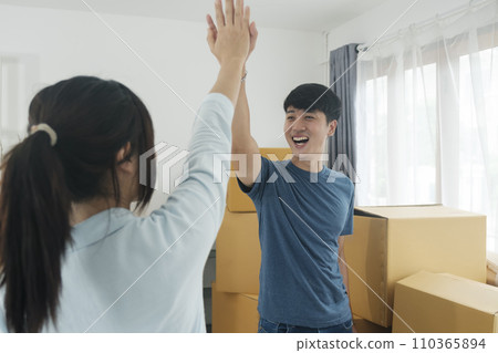 Happy couple with cardboard boxes in new house at moving day. Happy couple with cardboard boxes in new house at moving day. 110365894