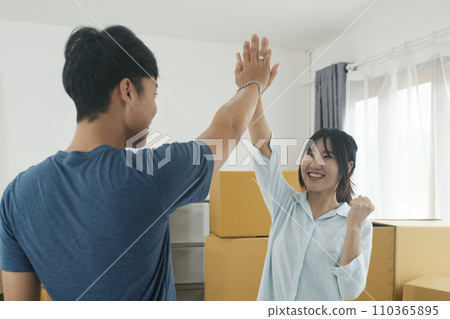 Happy couple with cardboard boxes in new house at moving day. Happy couple with cardboard boxes in new house at moving day. 110365895