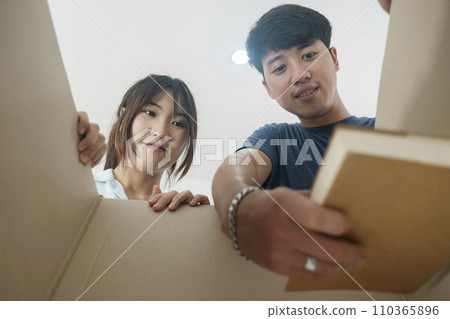 Asian young happy new married couple moving to their new house or real estate. Asian young happy new married couple moving to their new house or real estate. 110365896