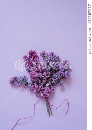 Bouquet of lilac flowers on a lilac background 110367057