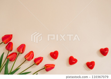 Flat lay valentines day frame with red tulips and and red heart on a light background with copy space 110367079