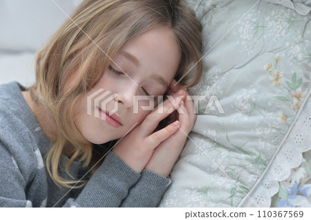 Sweet little girl sleeping in a bed 110367569