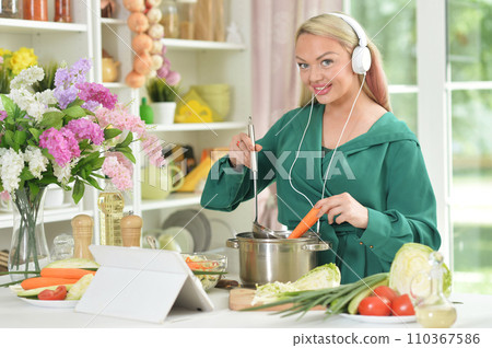 beautiful emotional young woman cooking in kitchen beautiful emotional young woman cooking in kitchen 110367586