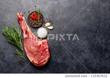 Raw Tomahawk beef steak and spices Raw Tomahawk beef steak and spices 110367632