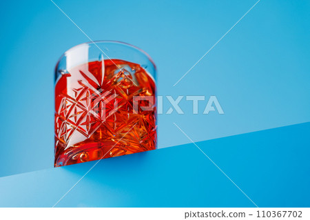 Classic negroni against a cool blue background Classic negroni against a cool blue background 110367702