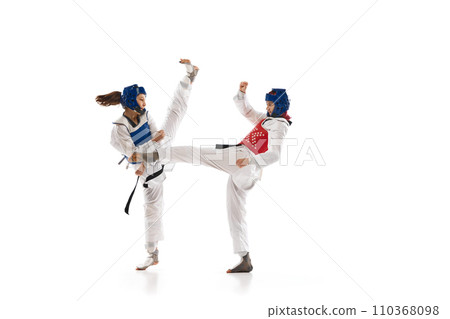 Leg kick. Young girl, competitive taekwondo athletes in dobok and helmet training isolated over white background 110368098