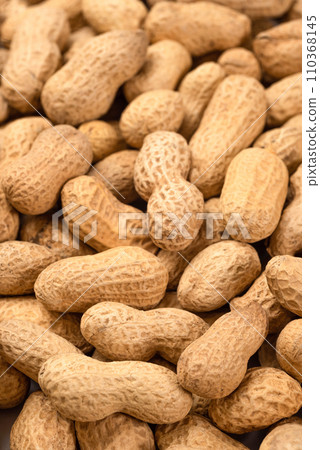 Unshelled peanuts as a background, top view. Food peanut closeup Unshelled peanuts as a background, top view. Food peanut closeup 110368145