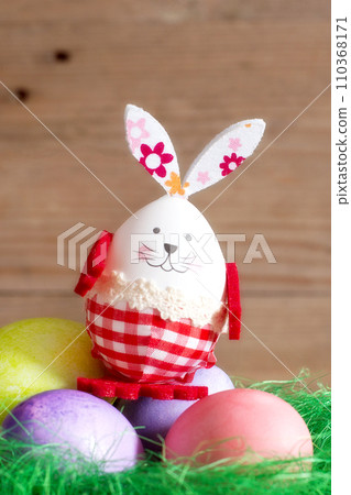 Colorful Easter eggs, green nest and bunny rabbit Colorful Easter eggs, green nest and bunny rabbit 110368171