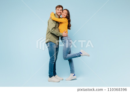 Joyful couple embracing, woman lifted in romantic hug Joyful couple embracing, woman lifted in romantic hug 110368396