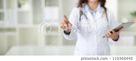 Cropped of woman doctor with digital tablet touching screen Cropped of woman doctor with digital tablet touching screen 110368448