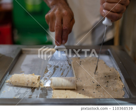 Artisan Crafting Rolled Ice Cream on a Hot Plate Indoors Artisan Crafting Rolled Ice Cream on a Hot Plate Indoors 110368539