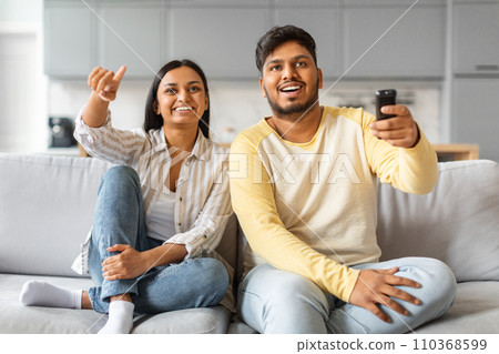 Portrait Of Happy Indian Spouses Watching Tv At Home Together 110368599