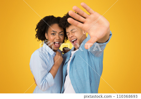 Sad excited young african american guy and woman in casual with open mouth Sad excited young african american guy and woman in casual with open mouth 110368693