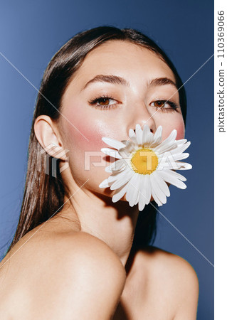 Beauty in Bloom: Young Woman with Attractive Portrait Surrounded by Floral Glamour on a Green Background Beauty in Bloom: Young Woman with Attractive Portrait Surrounded by Floral Glamour on a Green Background 110369066