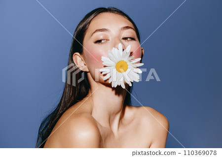 Floral Beauty: A Young Caucasian Woman with Attractive Face and Pretty Portrait, Posing in Fresh Spring Blossoms with a Background of Summer Nature. 110369078