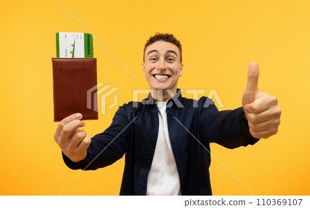 Excited Guy Holding Showing Boarding Pass Passport And Thumb Up Excited Guy Holding Showing Boarding Pass Passport And Thumb Up 110369107