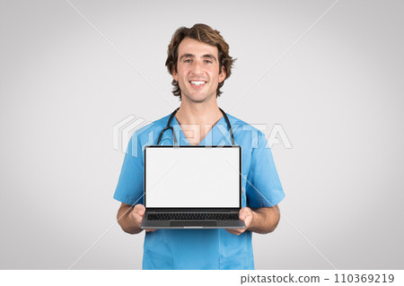 Happy male nurse presenting laptop with white blank screen 110369219