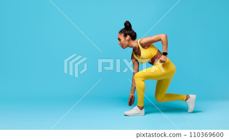 African American Woman Runner Doing Crouch Start Over Blue Background 110369600