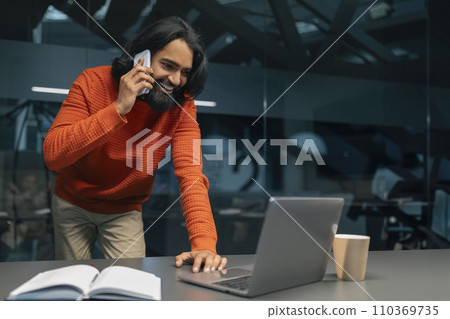 Millennial indian man project manager working at modern office 110369735