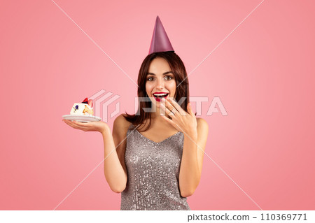 Happy millennial caucasian brunette woman in party cap, dress make wish 110369771