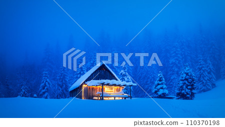 A serene winter scene with a lonesome wooden house 110370198