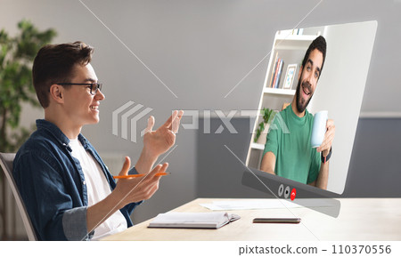 business guy immersed in virtual video meeting with coworker indoor 110370556